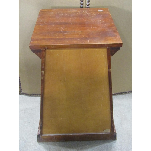 1189 - A small stained hardwood pedestal side cupboard, of tapered form, the stepped top above a panelled d... 