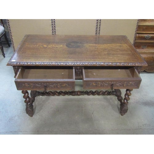 1213 - A 19th century carved oak writing table on barley twist legs, fitted with two frieze drawers, 75cm h... 