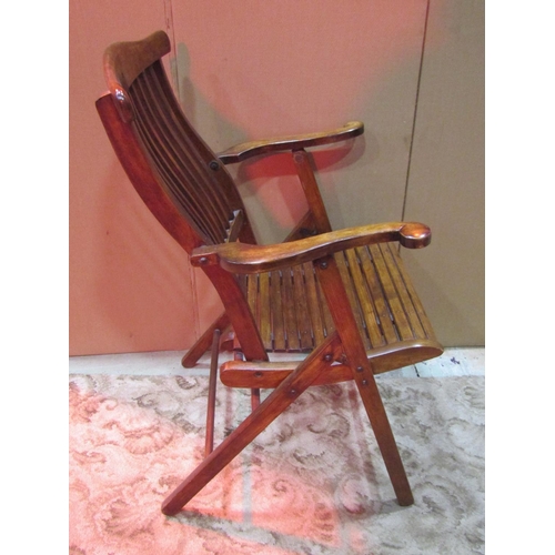 1244 - An Edwardian  folding chair with shaped arms, slatted seat and rail back