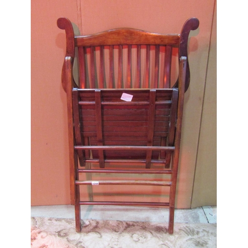 1244 - An Edwardian  folding chair with shaped arms, slatted seat and rail back