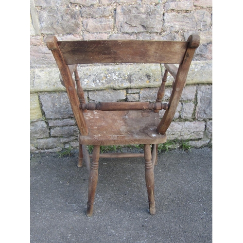 1257 - A Windsor bar-back kitchen chair with shaped arms