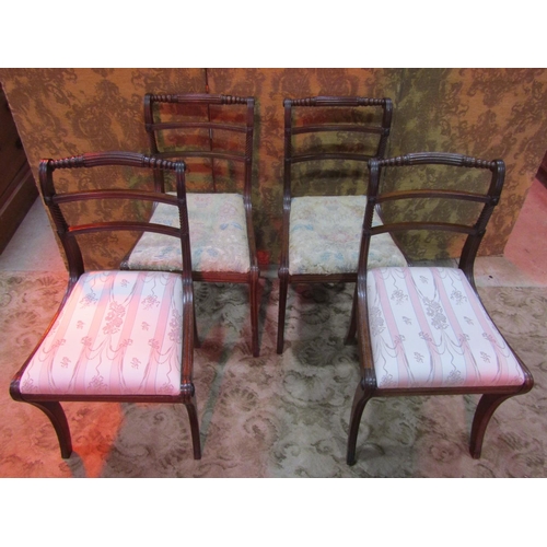 1260 - A set of four Regency mahogany bar back dining chairs with reeded frames, drop-in seats and sabre su... 