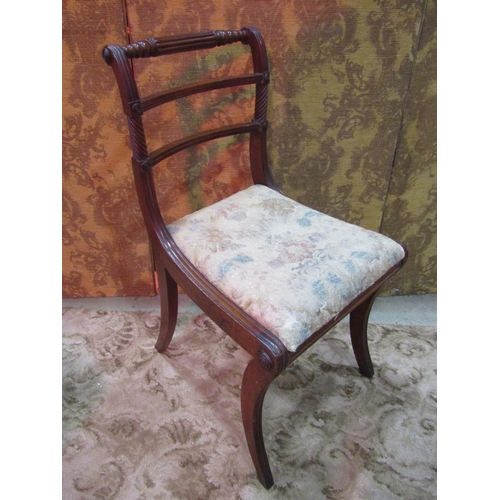 1260 - A set of four Regency mahogany bar back dining chairs with reeded frames, drop-in seats and sabre su... 