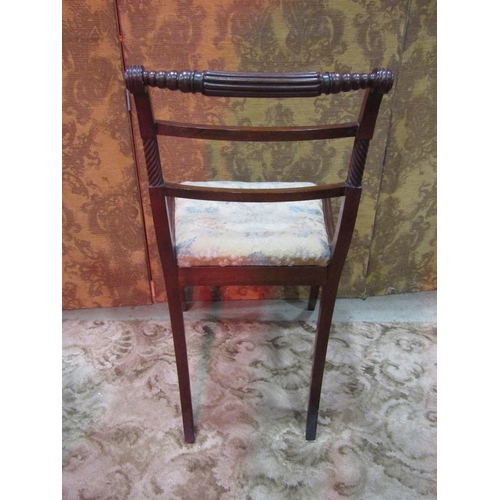 1260 - A set of four Regency mahogany bar back dining chairs with reeded frames, drop-in seats and sabre su... 