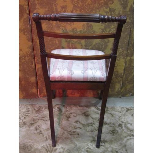 1260 - A set of four Regency mahogany bar back dining chairs with reeded frames, drop-in seats and sabre su... 