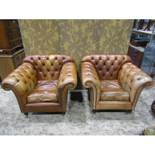 1273 - A Pair of good quality contemporary but traditional style tan leather button back armchairs, raised ... 