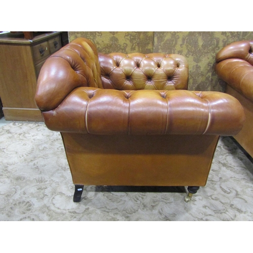 1273 - A Pair of good quality contemporary but traditional style tan leather button back armchairs, raised ... 