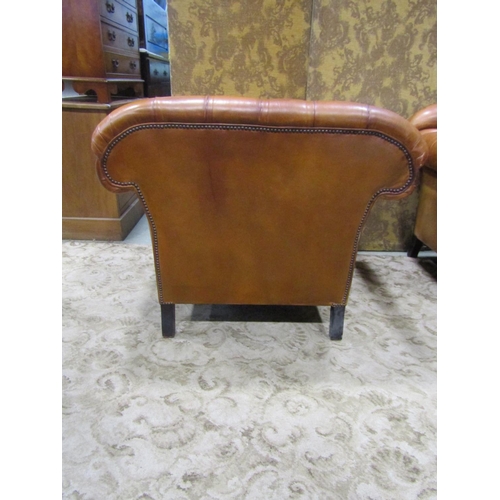 1273 - A Pair of good quality contemporary but traditional style tan leather button back armchairs, raised ... 