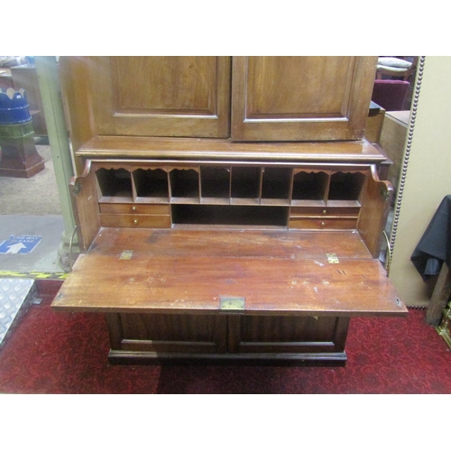 1312 - A Georgian mahogany secretaire with brass button press release fall front, enclosing a pigeon hole a... 