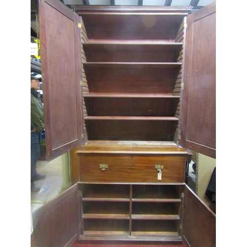 1312 - A Georgian mahogany secretaire with brass button press release fall front, enclosing a pigeon hole a... 