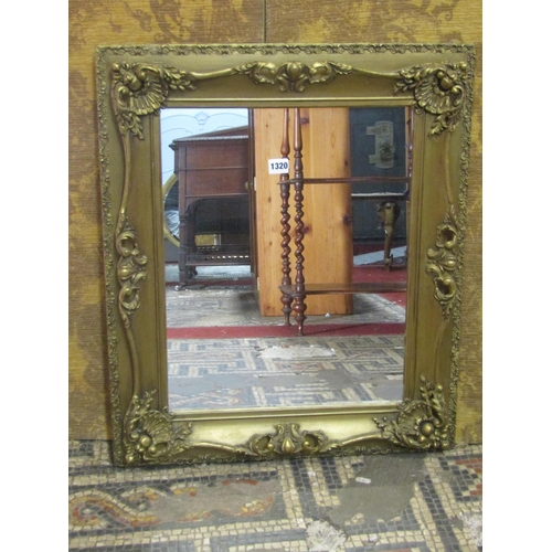 1320 - A swept stepped and moulded rectangular gilt framed wall mirror with scrolling acanthus detail, 69 c... 