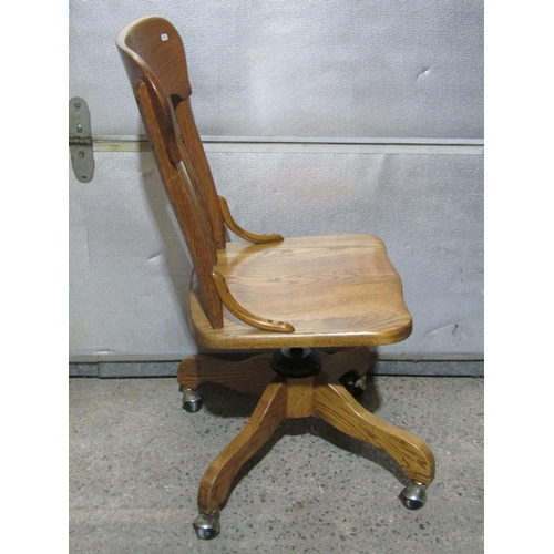 1383 - An ash swivel desk chair with slatted back