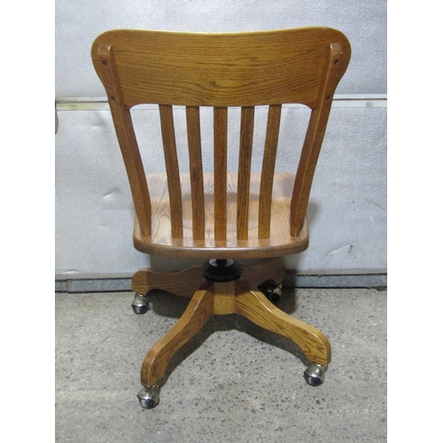 1383 - An ash swivel desk chair with slatted back