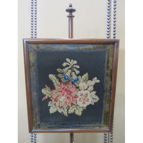 1167 - A Victorian rosewood pole screen with framed floral tapestry rise and fall panel raised on a turned ... 