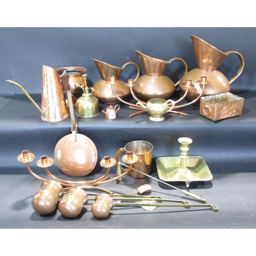 542 - Collection of copper and brass ware, including three graduated ale jugs, candlesticks, casket ladles... 