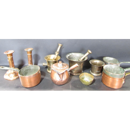 545 - A mixed selection of copper ware, including a tea caddy, a pair of candlesticks, a powder horn, and ... 