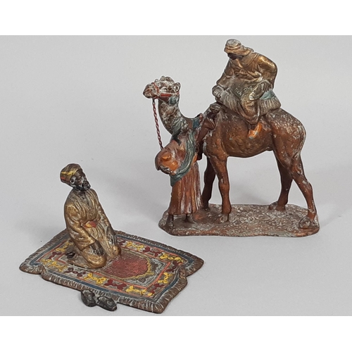 456 - Two painted spelter groups comprising a cold painted camel and attendant and a further worshipper up... 