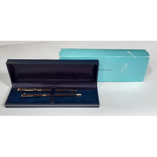 459 - Tiffany & Co ballpoint pen and matching propelling pencil set in silver and gold plated finish, with... 