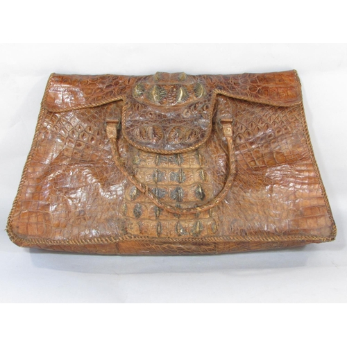 A crudely made crocodile skin bag with a division to interior 54cm wide x 34cm approx.