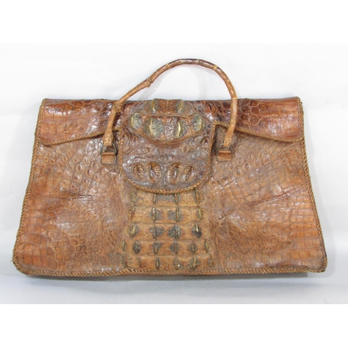 619 - A crudely made crocodile skin bag with a division to interior 54cm wide x 34cm approx.