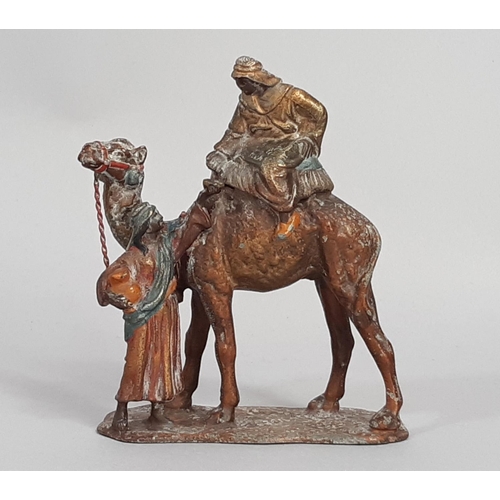 456 - Two painted spelter groups comprising a cold painted camel and attendant and a further worshipper up... 