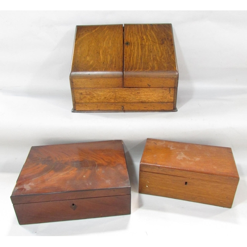 624 - An Edwardian oak desk top stationery box with a fitted interior, together with two mahogany boxes.