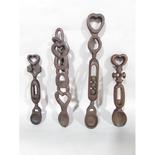 628 - Four Welsh love spoons, intricately carved.