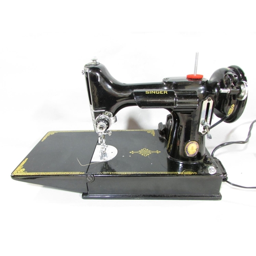 633 - A Singer Portable Electric Sewing Machine, No 221K , and B.R.K motor and foot controller, together w... 