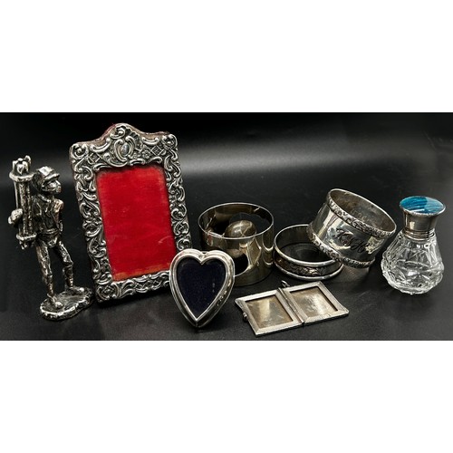 268 - A mixed selection of silver including a photo frame 9 x 6 cm, a silver locket, two napkin rings, a h... 