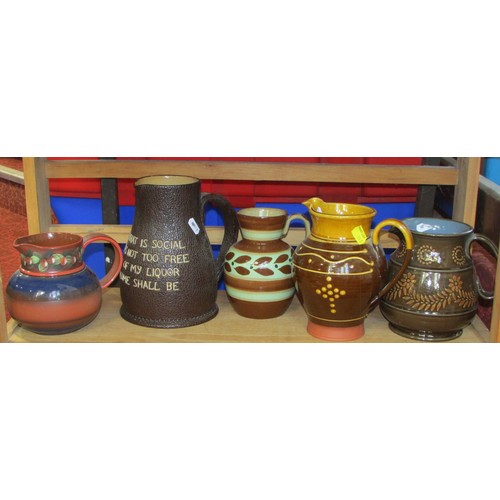 152 - Miscellaneous collection of 19th century and later jugs to include a Doulton Jack with script, Staff... 