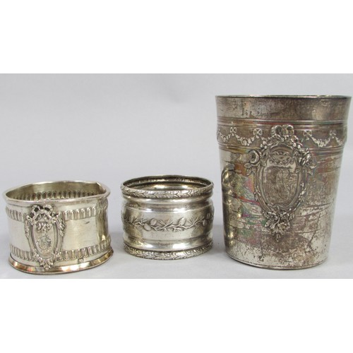 255 - A silver French beaker, bearing the head of Minerva, two napkin rings, a clawed sugar tong, three as... 