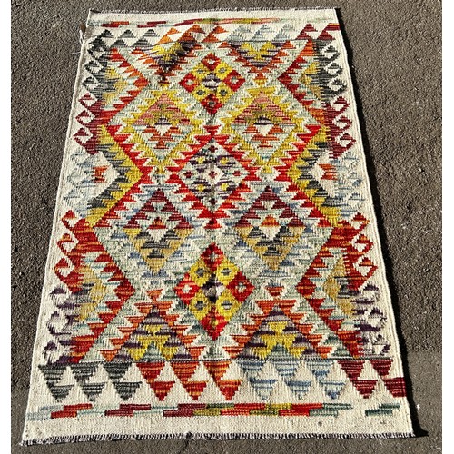 1591 - A Chobi kilim, with a multicoloured radiating diamond pattern, 128 x 79 cm