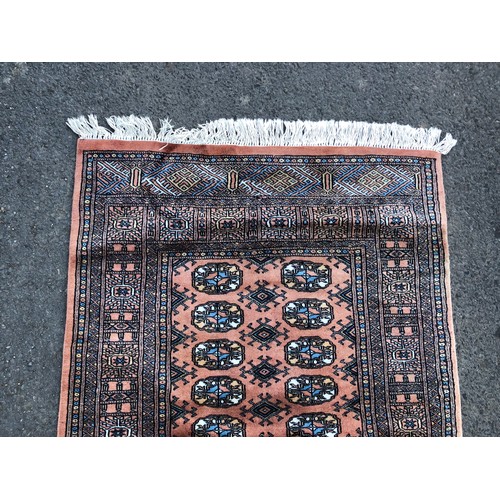 1571 - Pakistani Bokhara rug, with traditional design on an earth brown ground with black and blue details,... 