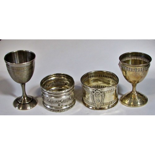 255 - A silver French beaker, bearing the head of Minerva, two napkin rings, a clawed sugar tong, three as... 