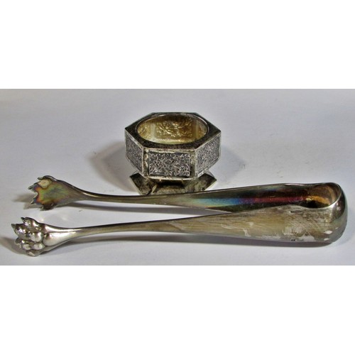 255 - A silver French beaker, bearing the head of Minerva, two napkin rings, a clawed sugar tong, three as... 