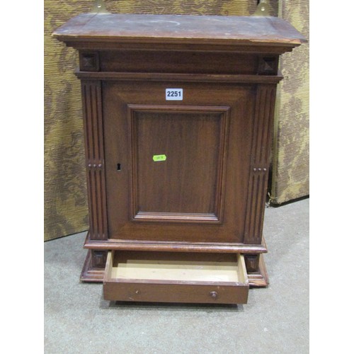 1232A - A small late Victorian mahogany hanging wall cupboard enclosed by a rectangular panelled over a frie... 