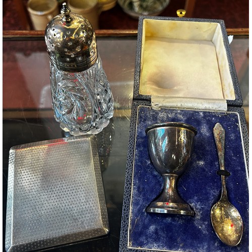 287 - A mixed selection of silver items including a sugar sifter, an egg cup & spoon, an engine turned 8 d... 