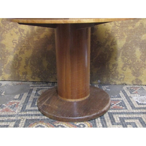 1158 - A small mid 20th century walnut occasional table, raised on cylinder stem and circular foot, with a ... 