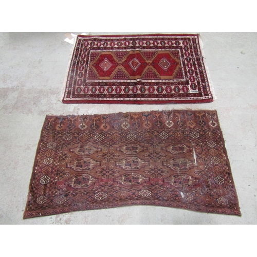 1572 - An old Bokhara section of rug worn and torn, together with a Turkoman type rug with stepped medallio... 