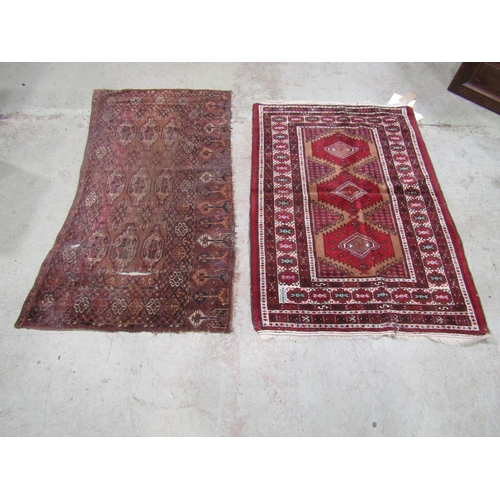 1572 - An old Bokhara section of rug worn and torn, together with a Turkoman type rug with stepped medallio... 