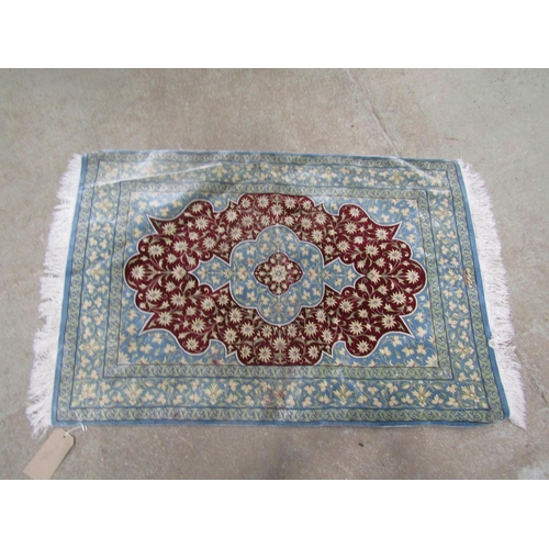 1573 - A small silk Persian rug with an all over floral pattern, signed lower centre, 114cm x 78cm.