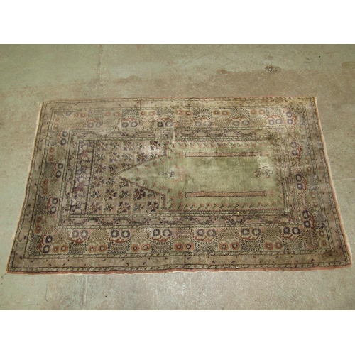 1576 - An old Middle Eastern prayer mat in pale green floral patterns, 135cm x 84cm