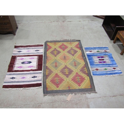 1577 - A Kilim carpet with diagonal trellis pattern, 150cm x 98cm and two kilim type mats 125cm x 72cm, (3)