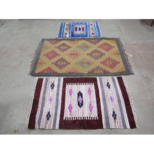 1577 - A Kilim carpet with diagonal trellis pattern, 150cm x 98cm and two kilim type mats 125cm x 72cm, (3)