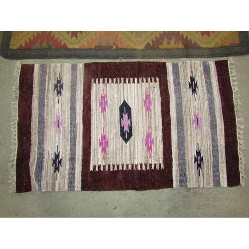 1577 - A Kilim carpet with diagonal trellis pattern, 150cm x 98cm and two kilim type mats 125cm x 72cm, (3)