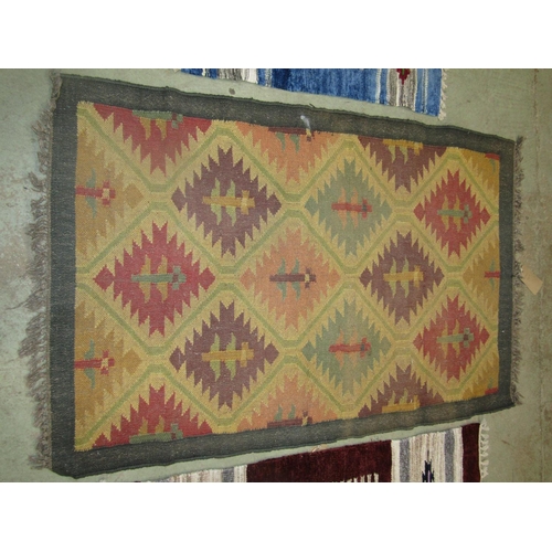 1577 - A Kilim carpet with diagonal trellis pattern, 150cm x 98cm and two kilim type mats 125cm x 72cm, (3)