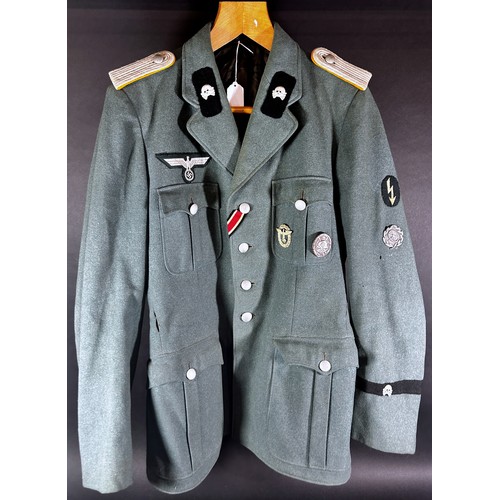 531 - German Third Reich Military interest. An original German military tunic with a miscellaneous selecti... 