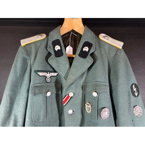 531 - German Third Reich Military interest. An original German military tunic with a miscellaneous selecti... 