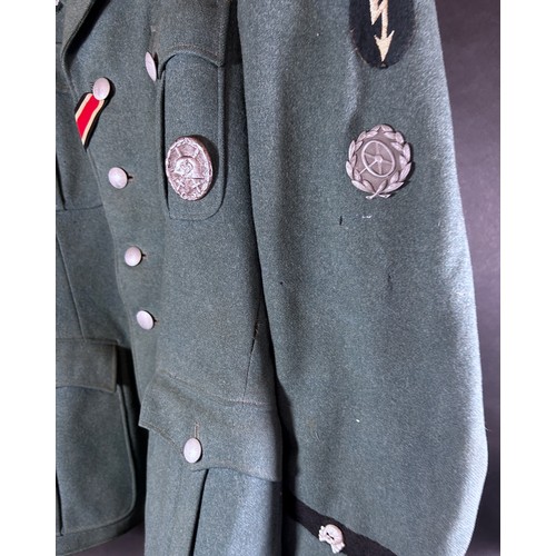 531 - German Third Reich Military interest. An original German military tunic with a miscellaneous selecti... 