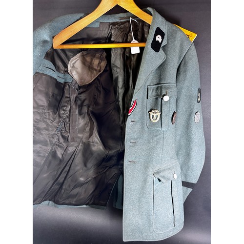 531 - German Third Reich Military interest. An original German military tunic with a miscellaneous selecti... 